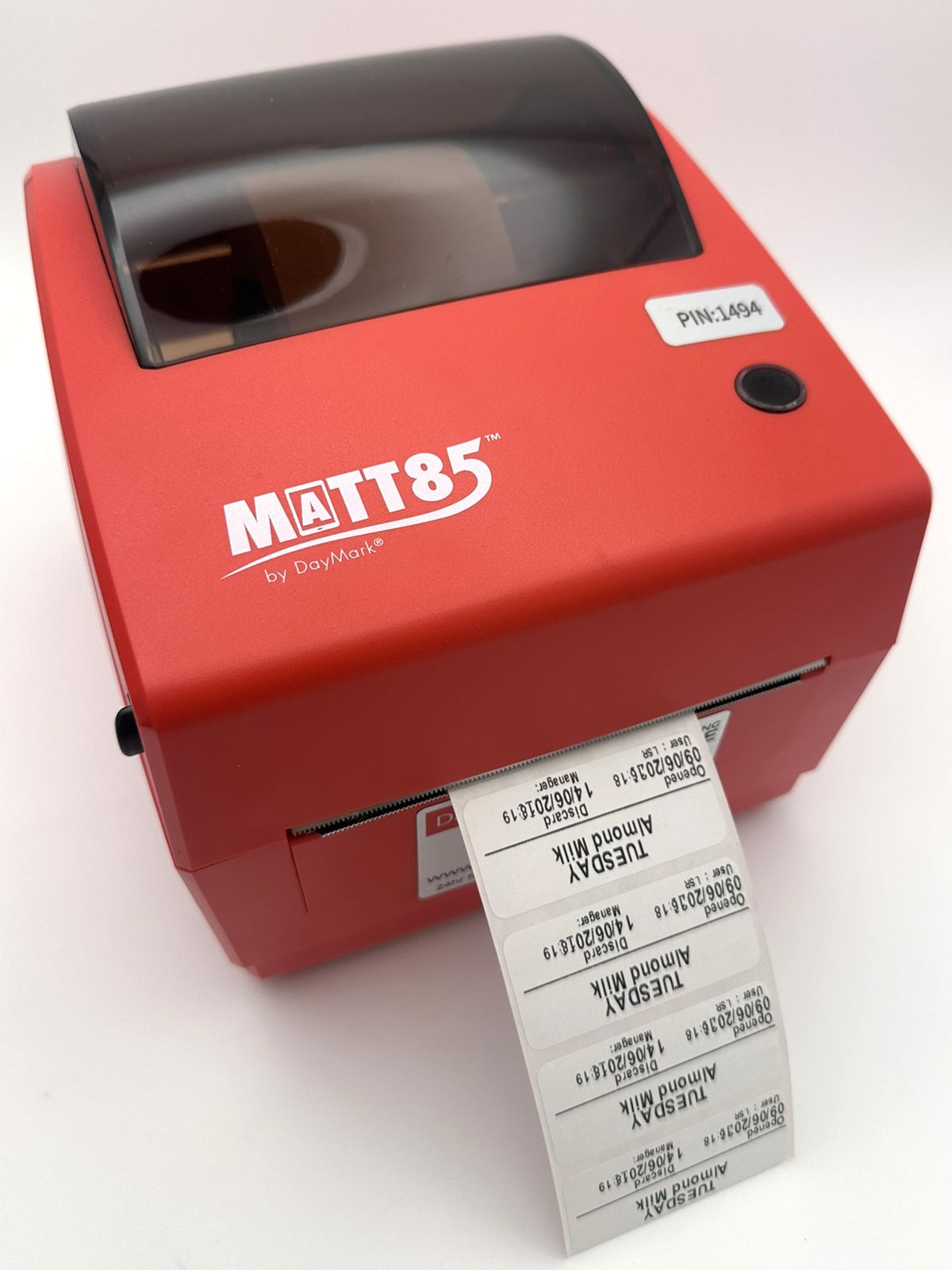 Matt 85 label printer with a roll of labels on a white background